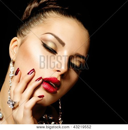 Picture or Photo of Beauty Woman with Perfect Makeup. Beautiful Professional Holiday Make-up. Red Lips and Nails. Beauty Girl