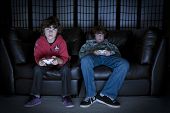 pic of game  - Two boys sitting on a couch playing video games - JPG 