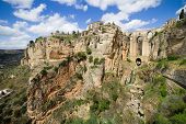 stock photo of bridge  - Picturesque scenery in Andalucia region of Spain rock formation and the New Bridge in Ronda Malaga province Spain - JPG 