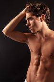 image of males  - Studio shot of a young sexy male adult looking to the side with one hand on the head - JPG 
