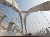 stock photo of bridge  - A modern arch bridge for cyclists and pedestrians - JPG 
