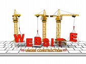 image of construction  - Cranes building a website on a computer keyboard concept of website under construction - JPG 