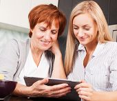 foto of home  - Mother and daughter looking in tablet pc - JPG 