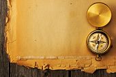 stock photo of geography  - Antique brass compass over old paper background - JPG 