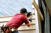 pic of home  - Young homeowner installs siding to his home - JPG 