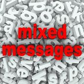 image of communication  - The words Mixed Messages on a background of random letters and words to illustrate poor communication or a bad misunderstanding between people involved in mistaken communication - JPG 