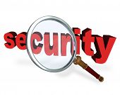 stock photo of security  - The word Security under a magnifying glass to symbolize searching for a secure and safe answer to a danger - JPG 