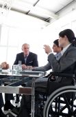 picture of business people  - Businesswoman in a wheelchair during a meeting with her team - JPG 