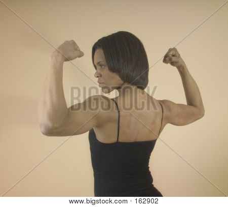 Strong Woman Flexing Her Arm Muscles | Stock photo. download preview Strong Woman Flexing Her Arm Muscles | Stock photo. download preview