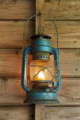 picture of blue  - Rusty lit blue lantern hanging in an old shed - JPG 
