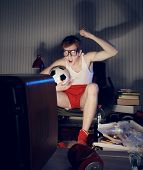 stock photo of competition  - Nerd boy excited by goal scored during soccer competition - JPG 