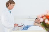 foto of pressure  - Doctor taking the blood pressure of male patient in a hospital - JPG 