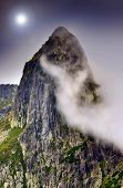 foto of sky  - dark scene of mountain landscape with mist and tall rock
 - JPG 