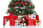 image of wrapped  - Decorated Christmas tree with baubles and tinsel surrounded by gift wrapped presents and a teddy bear - JPG 