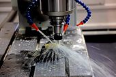 stock photo of industrial  - A CNC milling machine milling heads in metal industry - JPG 
