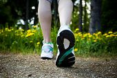 pic of walking  - Woman walking cross country and trail in spring forest - JPG 