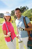 foto of golf  - Couple playing golf on a sunny day - JPG 