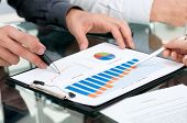 picture of finance  - Closeup of business people analyzing growing charts during a meeting - JPG 