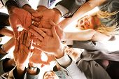 picture of teamwork  - business people teamwork in an office with hands together - JPG 