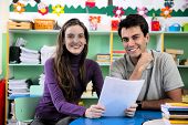 stock photo of meeting  - Teachers or teacher and parent having a discussion in classroom - JPG 