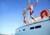 pic of transportation  - Young couple jumping in water from yacht - JPG 