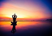 picture of sunset  - Yoga woman sitting on sea coast at sunset - JPG 