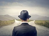foto of businessmen  - businessman with hat in front of two roads - JPG 
