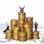 picture of money  - business people on  euro money piles - JPG 
