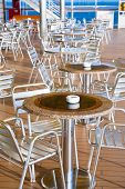 picture of pulldown  - tables with ashtrays in outdoor bar on stern of cruise liner - JPG 
