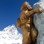 image of wall street  - Picture of a fake climber on a wall with mount Cervino in background - JPG 