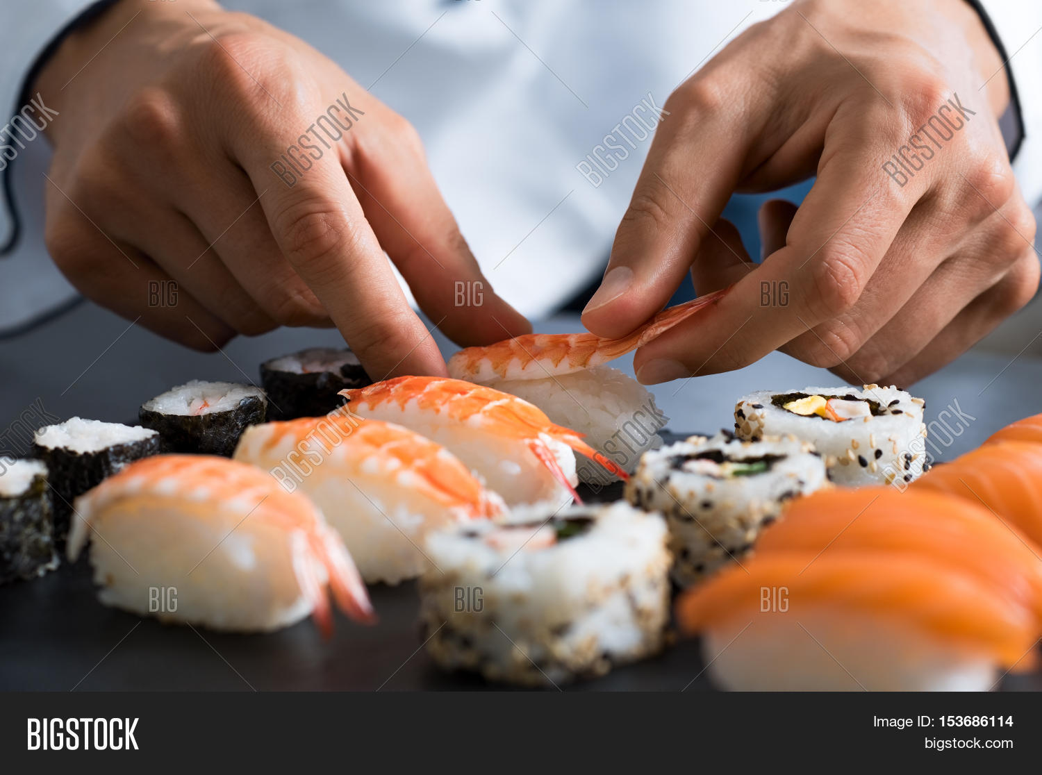 Closeup of chef hands preparing japanese food. Japanese chef making