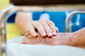 stock photo of lady  - Caring doctor or nurse holding elderly lady - JPG 