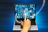 stock photo of computer technology  - hand touching a laptop screen with people photos - JPG 