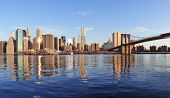 pic of bridge  - Brooklyn Bridge with lower Manhattan skyline panorama in the morning with cloud and river reflection over East River in New York City - JPG 
