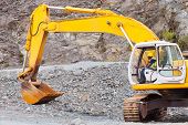 stock photo of construction  - african road construction worker operating excavator on construction site - JPG 