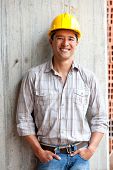 picture of construction worker  - Male construction worker at a building site smiling - JPG 