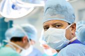 picture of medical doctors  - male doctor in operation room with his team - JPG 