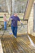 pic of pressure  - Contractor pressure washing deck that raps around house getting home ready to sell - JPG 