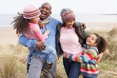 pic of laughter  - Family Walking Along Dunes On Winter Beach - JPG 