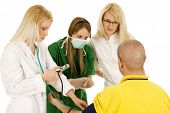 stock photo of bloodpressure  - medical team with female doctors measuring bloodpressure isolated over white background - JPG 