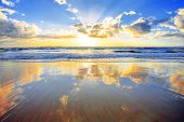 picture of beach  - Spectacular golden sunrise over ocean with beach in foreground - JPG 