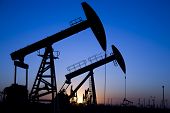 pic of pressure  - Silhouette of oil pump jacks with sunset - JPG 