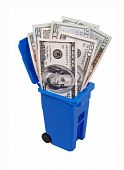foto of money  - Recycling saves money shown by a recycling bin full of money  - JPG 