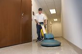 image of buildings  - cleaning person polishing office hallway in commercial building - JPG 
