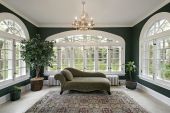 pic of interior  - Sunroom in luxury home with sofa and wall of windows - JPG 