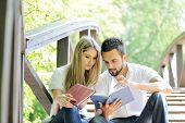 picture of reading  - Beautiful couple reading book outdoors - JPG 