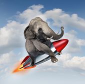 picture of possibility  - Courage and determination as a potential and possibilities concept with a realistic elephant flying in the air using a rocket as a business symbol of achievement and belief in your abilities to succeed in upward growth - JPG 