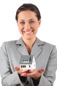 picture of construction worker  - businesswoman holding home on a white background - JPG 