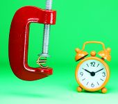 pic of pressure  - A golden Euro symbol placed in a red clamp with a pastel green background - JPG 