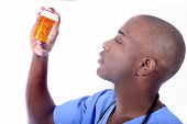 stock photo of bloodpressure  - african american nurse and pills giving out drugs - JPG 